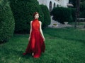 Pretty woman red dress walking luxury model outdoors Royalty Free Stock Photo