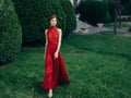 Pretty woman red dress walking luxury model outdoors Royalty Free Stock Photo