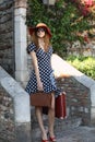 Pretty woman in red hat with suitcase Royalty Free Stock Photo