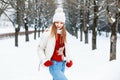Pretty woman in a red sweater, a white cap and a jacket, knitted Royalty Free Stock Photo