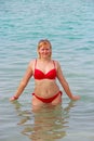 Young woman enjoying rest bathing in sea. Girl standing in sea Royalty Free Stock Photo