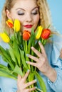 Pretty woman with red yellow tulips bunch Royalty Free Stock Photo