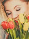 Pretty woman with red yellow tulips bunch Royalty Free Stock Photo