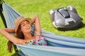 Pretty woman Relaxing In Hammock with automower in background