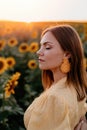 Pretty woman in retro dress posing in sunflowers field. Yellow colors, warm toning. Vintage timeless fashion, amazing Royalty Free Stock Photo