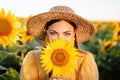 Funny woman in retro dress in sunflowers field. Yellow colors, warm toning. Royalty Free Stock Photo