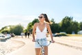 Pretty woman riding bicycle in city park cycle path and street. Bike promenade in summer. Happy smiling cyclist. Stylish trendy. Royalty Free Stock Photo