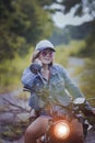 pretty woman riding sport enduro motorcycle on dirt field