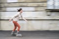 Pretty woman on roller skates skating with motion blur. Royalty Free Stock Photo