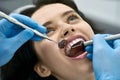 Pretty woman`s teeth treatment in dental clinic