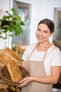 Pretty woman showing bread in basket Royalty Free Stock Photo