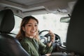 Pretty woman showing car keys in her newly bought auto smiling cheerfully sitting in the luxury vehicle Royalty Free Stock Photo