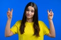 Pretty woman showing with hands and two fingers air quotes gesture, bend fingers isolated over blue background. Not Royalty Free Stock Photo
