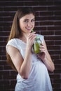 Pretty woman sipping on green juice Royalty Free Stock Photo