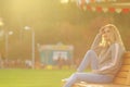 Pretty woman in sitting on the bench in city park Royalty Free Stock Photo