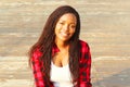 Pretty woman sitting in the city park, wearing a red checkered Royalty Free Stock Photo