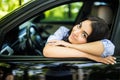 Pretty Young Woman Sitting Inside the Car, Smiling Leaning on the Open Window Royalty Free Stock Photo