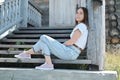 pretty woman sitting on a stairs of old abandoned wooden house Royalty Free Stock Photo