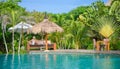 A Pretty woman sitting in the tropical shade a pool 2