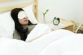 The pretty woman sleeping on bed with eyes mask