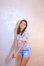 Pretty woman with smile posing on camera, standing on background Royalty Free Stock Photo