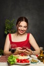 Pretty woman smiling, using phone and eating italian pasta Royalty Free Stock Photo