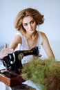 Pretty Woman. In the style of Coco Chanel sitting on a sewing machine Royalty Free Stock Photo