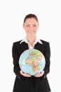 Pretty woman in suit holding a globe Royalty Free Stock Photo