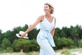 Pretty woman with summer hat enjoying sweet summer day. Outdoors summertime horizontal colored image