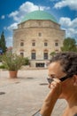 Pretty woman with sunglasses in Hungarian city Pecs, in front of the Turkish monument Dzsami Royalty Free Stock Photo