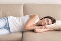 Pretty woman takes short nap during day on sofa Royalty Free Stock Photo