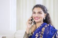 Pretty woman talking on mobile phone at home Royalty Free Stock Photo