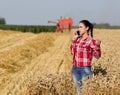 Pretty woman talking on mobile phone in wheat field Royalty Free Stock Photo