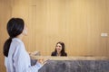 Pretty woman talking to her female client happily Royalty Free Stock Photo