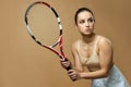 Pretty woman with tennis racket standing against yellow background Royalty Free Stock Photo