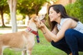 Pretty woman about to kiss her dog