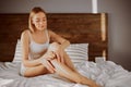 Pretty woman touching smooth legs Royalty Free Stock Photo