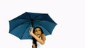 Pretty woman under blue umbrella cowering with fear