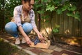 Pretty woman, vintner putting freshly picked organic grapes into a wooden box. Agribusiness. Close-up with copy ad space
