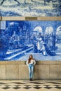 Pretty woman waiting at train station in Porto for travel in summer. Travel concept. Royalty Free Stock Photo