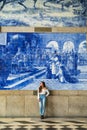 Pretty woman waiting at train station in Porto for travel in summer. Travel concept. Royalty Free Stock Photo