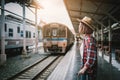 Pretty woman waiting the train at train station for travel in summer. Travel concept. Royalty Free Stock Photo