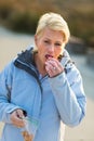 Young woman eating snacks on walk