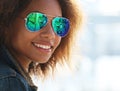 Pretty woman wearing sunglasses with perfect teeth and dark clean skin having rest outdoors Royalty Free Stock Photo