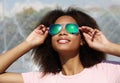pretty woman wearing sunglasses with perfect teeth and dark clean skin having rest outdoors Royalty Free Stock Photo