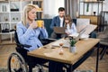 Disabled woman using lapotp while husband playing with kid Royalty Free Stock Photo