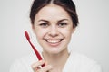 pretty woman in white robe brushing tongue hygiene