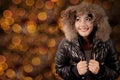 Pretty woman with winter jacket and sparkle light