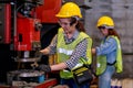 Pretty woman workers or technician are working with machine in factory Royalty Free Stock Photo