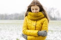 Pretty woman in a yellow knit scarf and yellow jacket. Outdoors